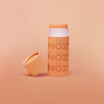Load image into Gallery viewer, Straight view of Nöz sunscreen in orange with its cap off.
