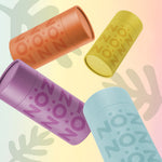 Load image into Gallery viewer, Angled view of Nöz sunscreen sticks shown in blue, yellow, orange, and purple.
